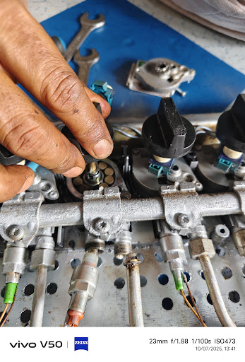 Technician fixing gas stove ignition and knobs